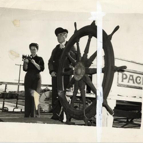 [Rose and Jack Kissinger standing on the deck of their sailing ship "Pacific Queen" (also known as the "Balclutha")]