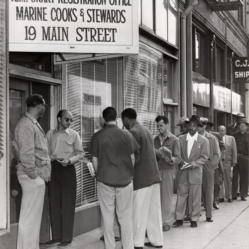 [Marine cooks and stewards lined up at a registration center at 19 Main Street]