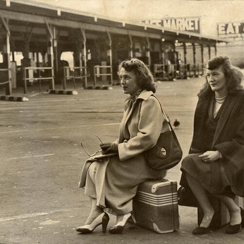 [Two travelers waiting in vain at a Greyhound Bus Depot during strike]