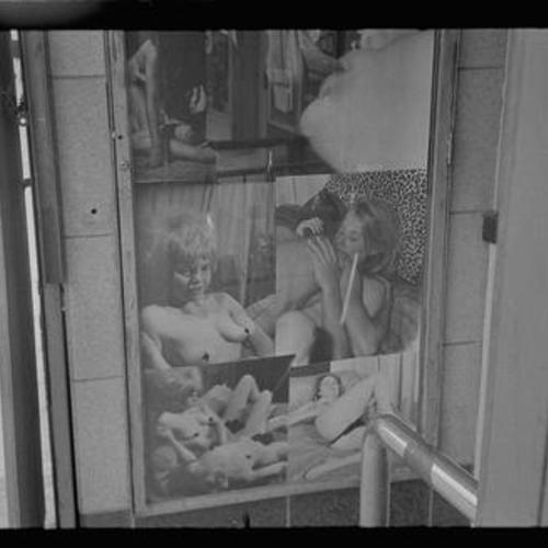 Exterior view of Gayety Theatre photo collage display of people in sexual poses and acts