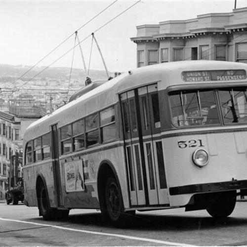 [Municipal Railway trackless trolley 'E' line, car number 521 ascending hill]