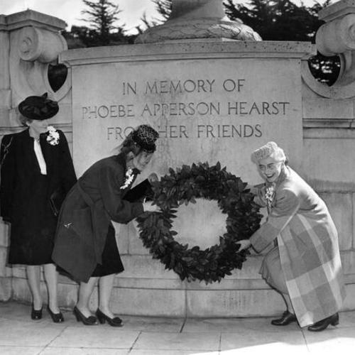 [Mrs. Rollin Brown, Mrs. Harvey Mitchell and Mrs. Dean Parker placing a wreath on the monument to Phoebe Apperson Hearst in Golden Gate Park]