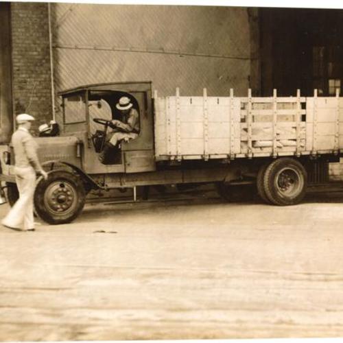 [Police officer and delivery truck during Longshoremen's Strike]