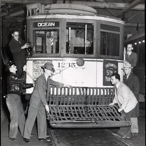 [Northern California Railroad Club members leading Market Street railroad 12 line streetcar out of Geneva avenue carbarn]