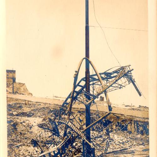 [Trolley pole, on Broadway near Montgomery Street, surrounded by wreckage after the 1906 earthquake and fire]