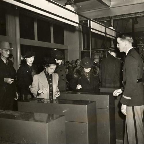 [Passengers passing though turnstiles at the Ferry Building]