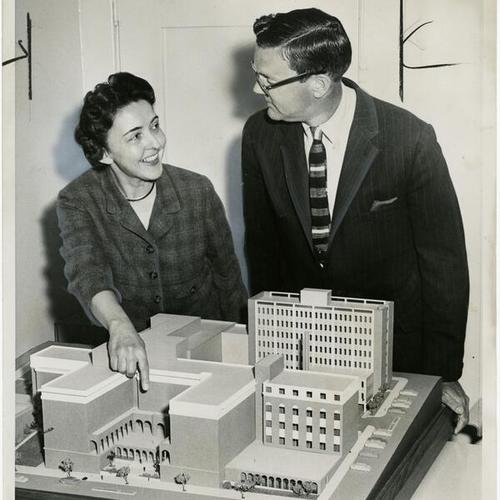 [Mrs. Ross Beales, president of Children's Hospital, and Roger Lapham Jr., general chairman, looking at a model of a planned addition to the hospital]