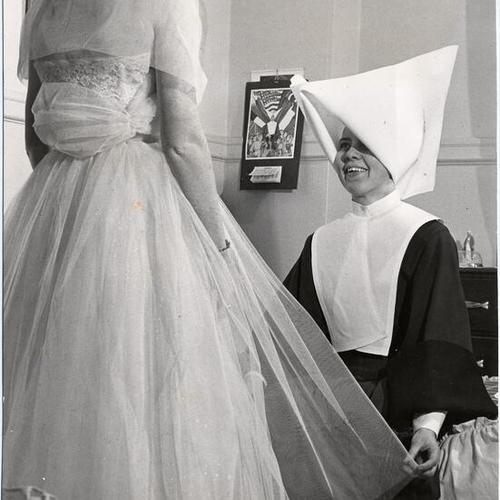  nun at Mount St. Joseph Orphanage helping a young woman prepare for a dance]