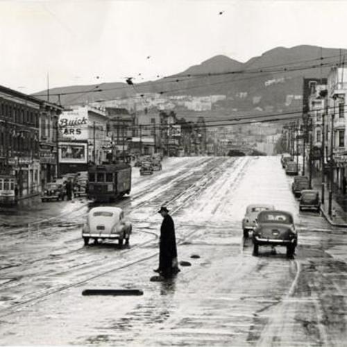 [Intersection of Market and Church Street on a rainy day, Twin Peaks in the background]