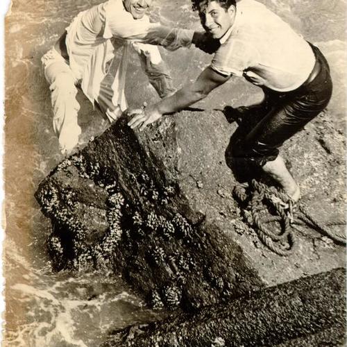 [Al Matteo helping Charlie Delps on to shore after Delps successfully dived off the Golden Gate Bridge into San Francisco Bay]