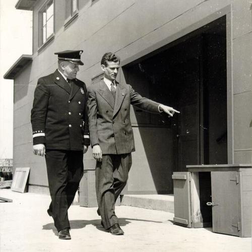 [R. S. Long leading Fire Chief Sullivan on a tour of Hunters Point Housing Project]