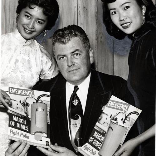 [Barbara Yee, Policeman George Pohley and Helen Low display posters for Chinatown March of Dimes Emergency Drive]