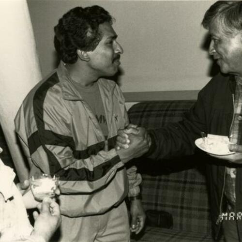 [Cesar Chavez, UFW president eating cake and greeting La Raza students at his birthday reception at the SFSU Student Union]