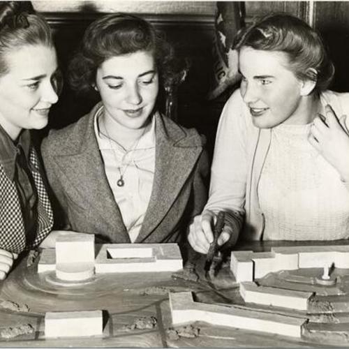 [Jane Knight, Marie Stich and Rosella Retallich posing with a model of the San Francisco Junior College campus]