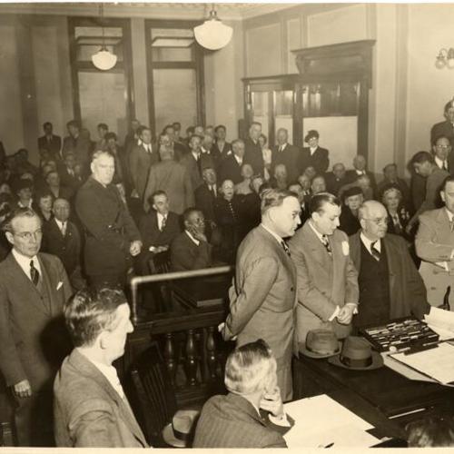 [Pat Brown, Jake Erlich, Francis Van Wie and Jim Toner standing in a courtroom]