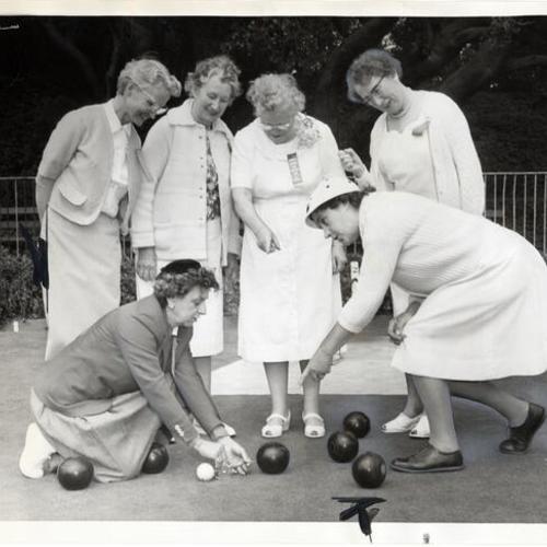 [India Evans, Mardie Ward, Margaret Headley, Betty Service, Priscilla Steinmetz and Jennie Higgins measure for points during a game on the bowling green in Golden Gate Park]