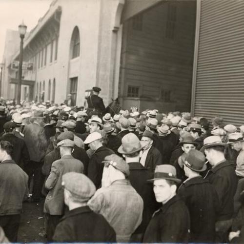 [Crowd of longshoremen and teamster pickets at the waterfront]