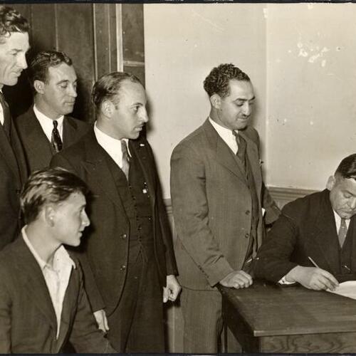 [W.R. Mays, seated at right, taking applications for the CCC Forestry Work Camps]