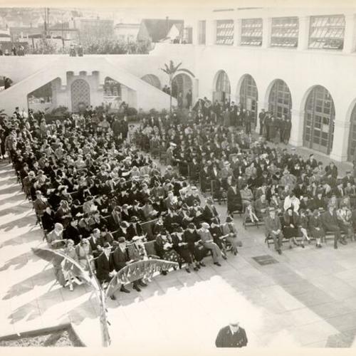 [Audience seated in courtyard for event at Sunshine Orthopedic School]
