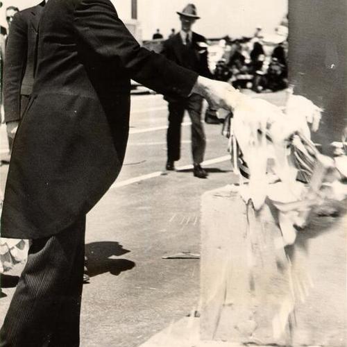 [William P Filmer, president of the Golden Gate Bridge and Highway District, formally christening and dedicating the bridge during opening day ceremonies]