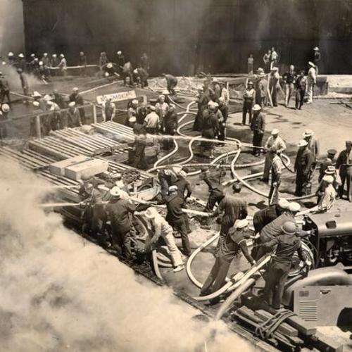 [Firemen fighting a fire on the United Fruit Company Pier at Third and Channel streets]