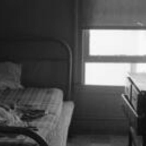 [Planters Hotel, 286 Second Street, interior of  a room showing bed, window, and dresser]