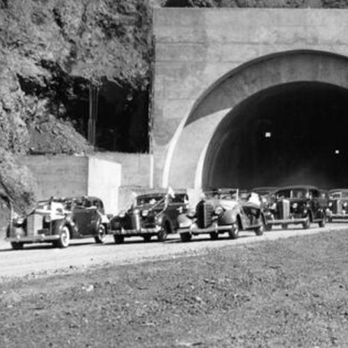 [Procession of autos driving through Waldo Tunnel on tunne's opening day]