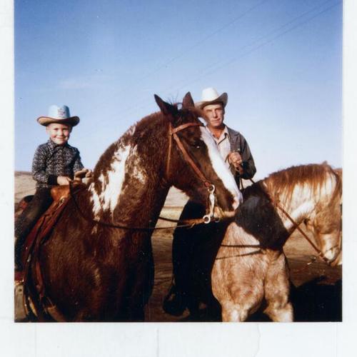 [Father and son horseback riding in Weiser, Idaho]