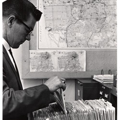 [Inspector Jack Webb checking files in Old Hall of Justice]