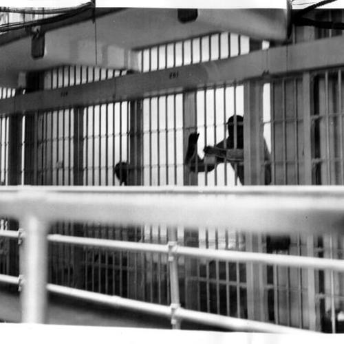 [Prisoner behind bars on Alcatraz]