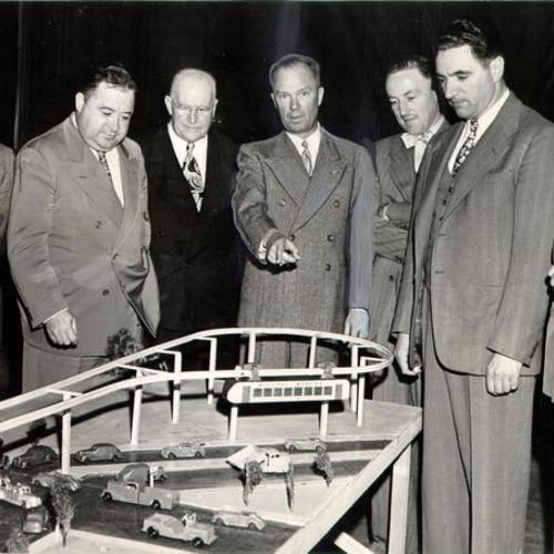 [San Francisco supervisors looking at a model of a proposed monorail system]