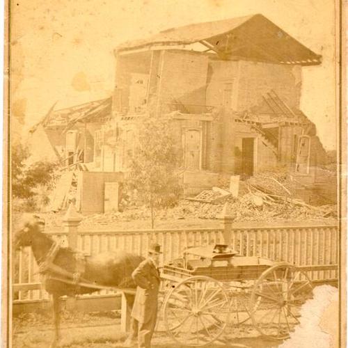 [Man with a horse and carriage standing near the ruins of a building after the 1868 earthquake]