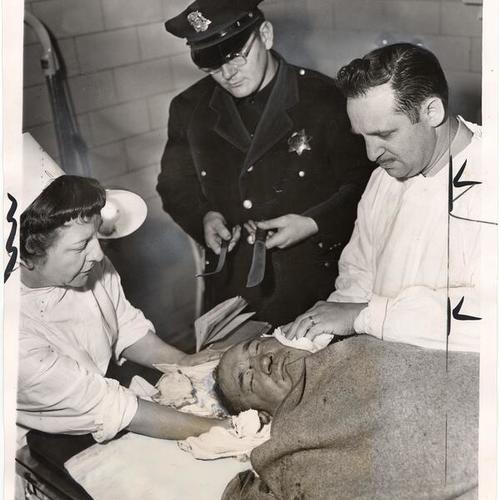 [Policeman Gus Bruneman, Nurse Noreen Shields and Steward Ben Glaser attending to a knifing victim at Central Emrgency Hospital]
