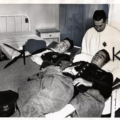 [Officers Timothy Casey and John ("Jack") Webb await examination in Mission Emergency Hospital, supervised by Steward Robert Beaudoin]