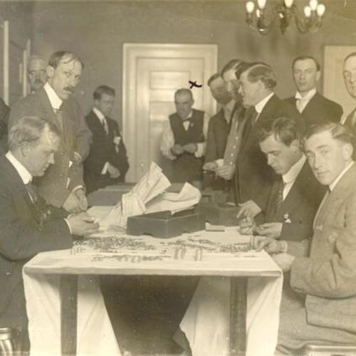 [Men counting coins at the St. Francis Hotel]
