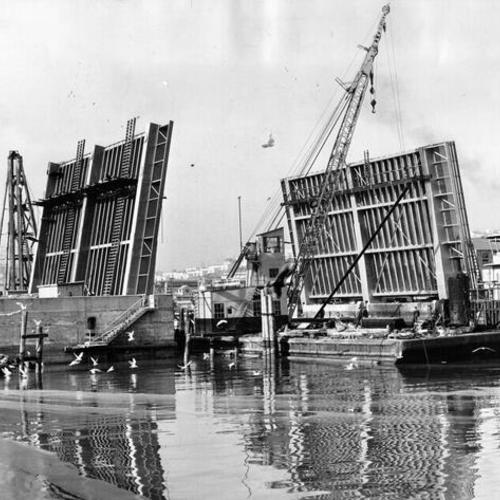 [View of Islais Creek Bridge on Third street being drawn apart to provide passage for water traffic]