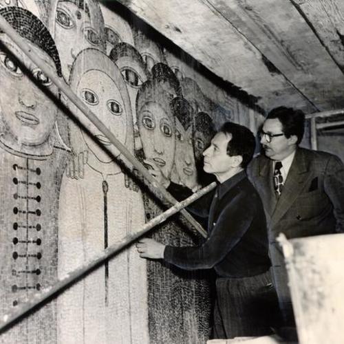 [Artist Beniamino Bufano and Ted Wetteland inspecting a mosaic mural created by Bufano]