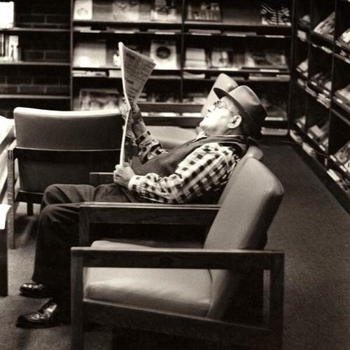 [Patron reading in the Bayview Branch library]