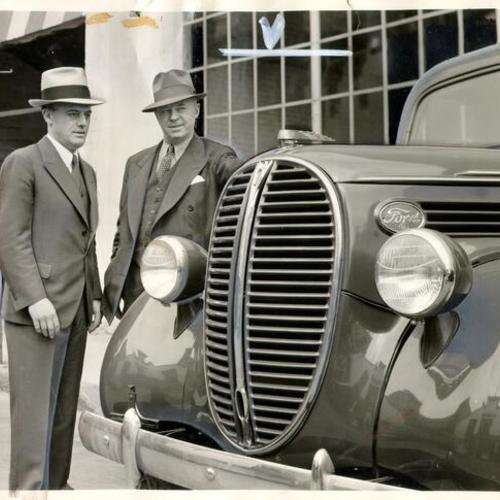 [Babe Maggini, head of Maggini Motor Car Company, talking to Tom R. Johnson of the Ford Motor Company]