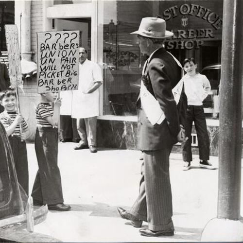 [V.L. Henderson of Local 148 in front of non-union Postoffice Barber Shop]