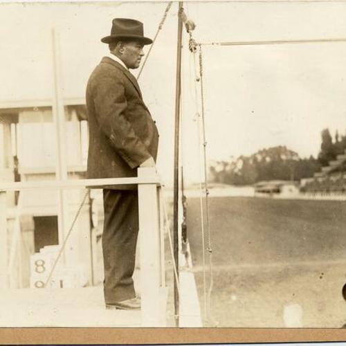 [Race official watching horse race at the Panama-Pacific International Exposition]