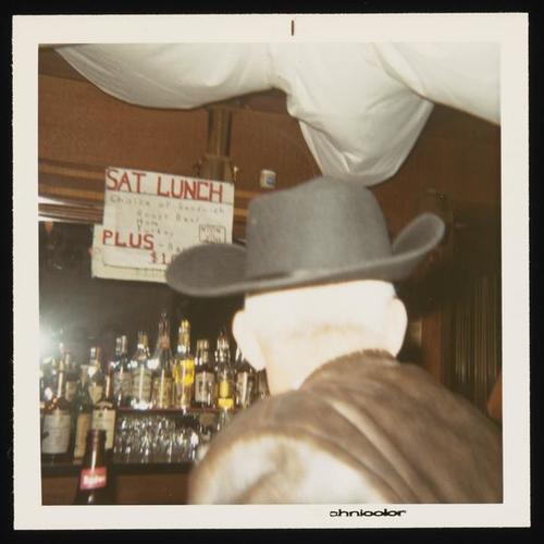 Person at bar in cowboy hat at Halloween party