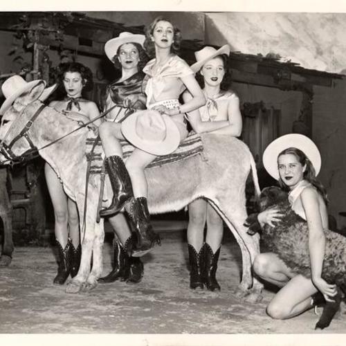 [Young women from Sally Rand's Nude Ranch wearing cowboy hats, gunbelts and boots posing with a donkey and a sheep, Golden Gate International Exposition on Treasure Island]