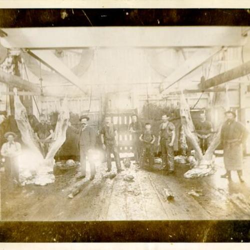 [Group of men posing for a picture in a slaughterhouse in Visitacion Valley]