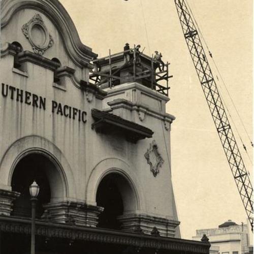 [Construction crew setting new bell tower in place on top of Southern Pacific Depot on 3rd Street]