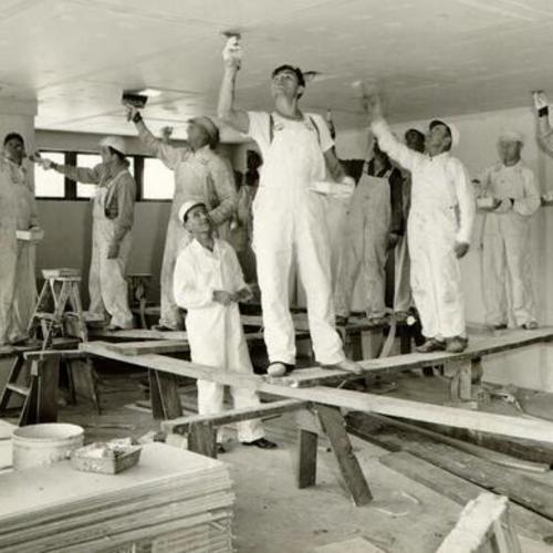 [Group of men painting the ceiling of the Hospitality House]