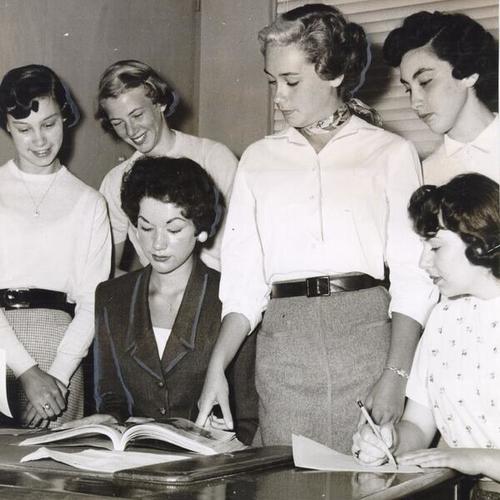[Members of a "High School Fashion Board" making plans for their fashion show at the opening of Hale's Mission store]