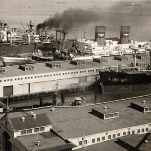 [View of ships docked at San Francisco piers, looking north from the Bay Bridge]