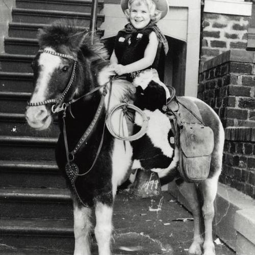 [Pamela on pony wearing a cowgirl costume]