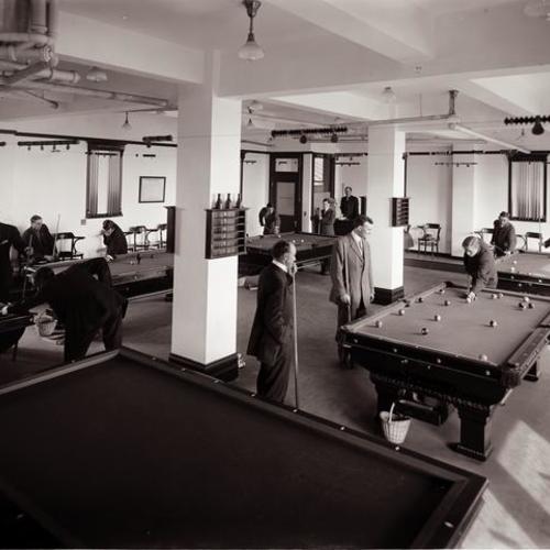 People playing at Y. M. C. A. billiard room